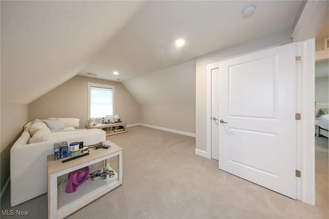 Bonus room with light carpet, vaulted ceiling, and recessed lighting