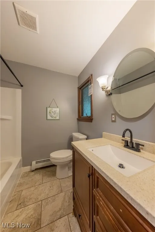 Full bathroom with single vanity and tub / shower combination located in the hallway on the first floor