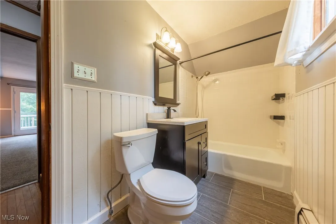 Full bathroom upstairs with single vanity and tub / shower combination