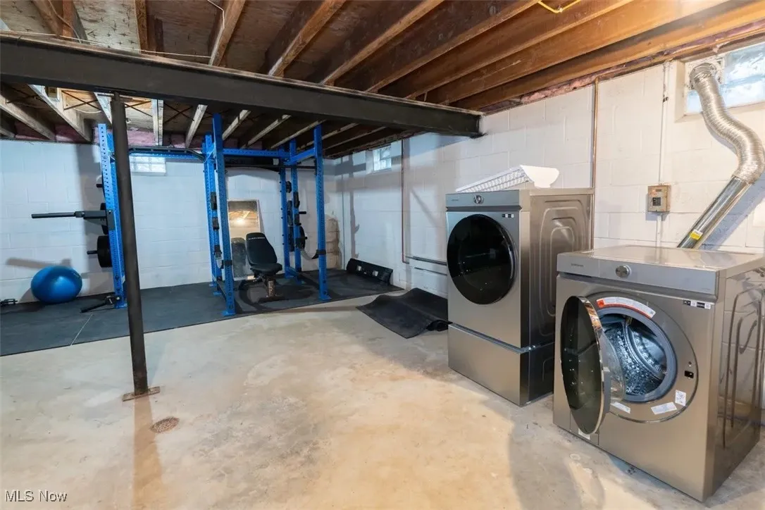 The laundry area is located in the unfinished basement with plenty of space for storage and other hobbies