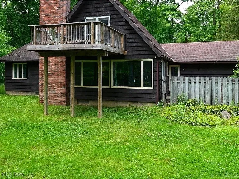 A view of the back of the house and second story deck