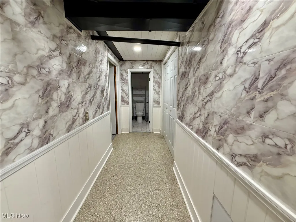 Corridor featuring speckled floor