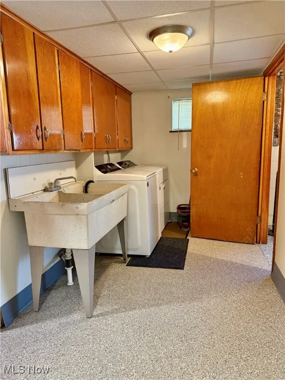 Laundry area with a sink and washer and clothes dryer