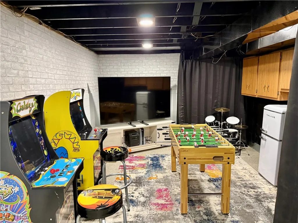 Playroom featuring brick wall