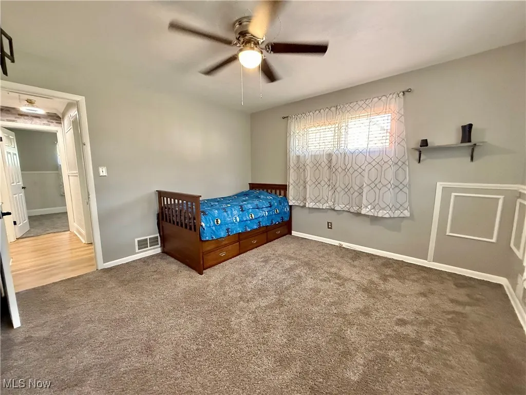 Bedroom with carpet floors and a ceiling fan