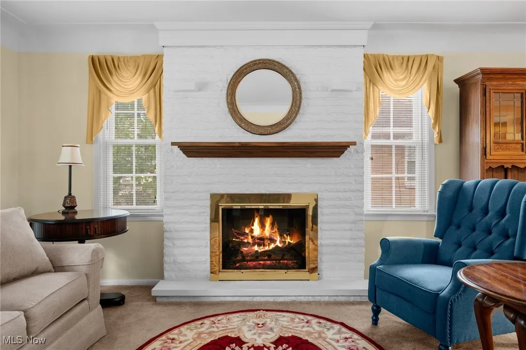 Sitting room featuring carpet flooring and a fireplace