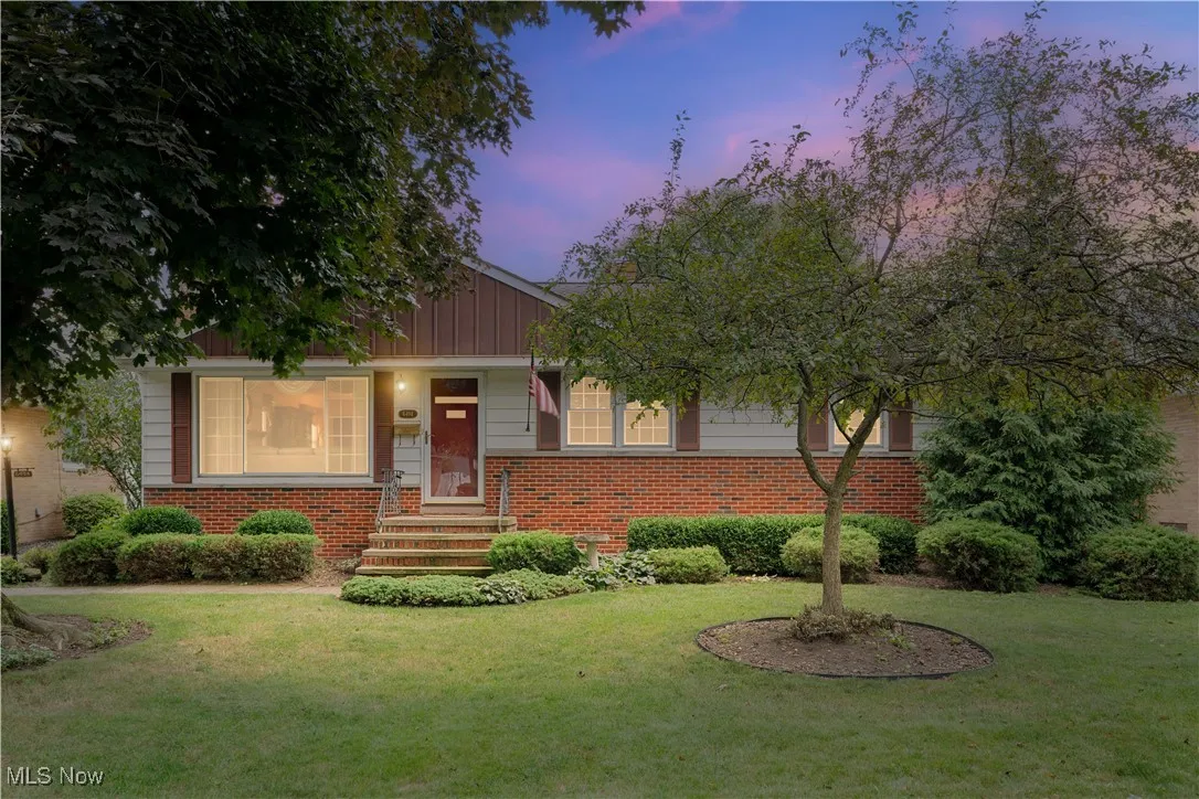 View of front of home featuring brick siding and a lawn