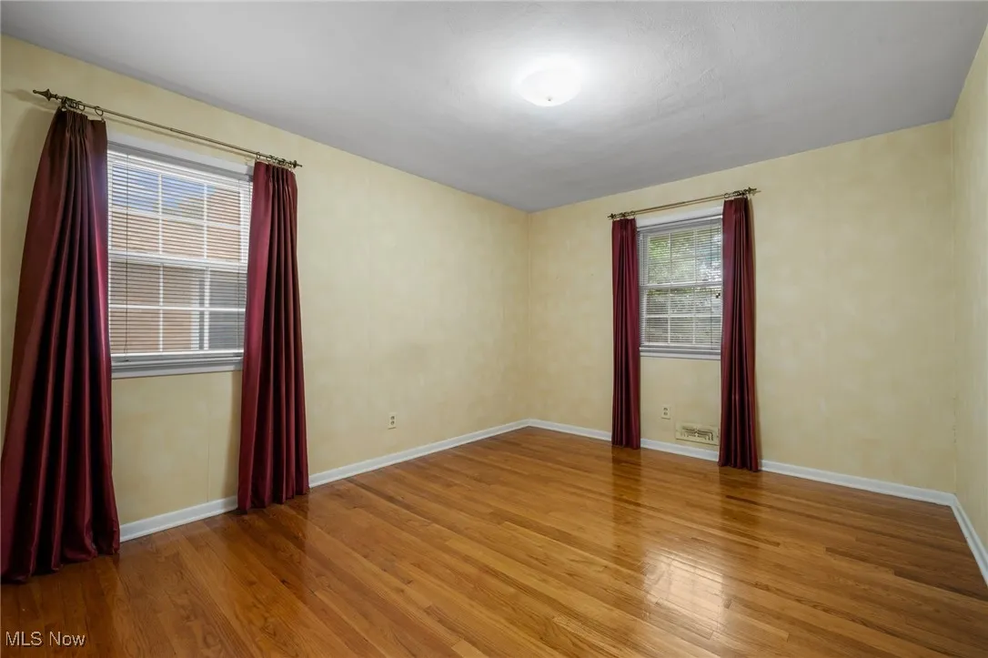 Empty room featuring light wood-style flooring and baseboards