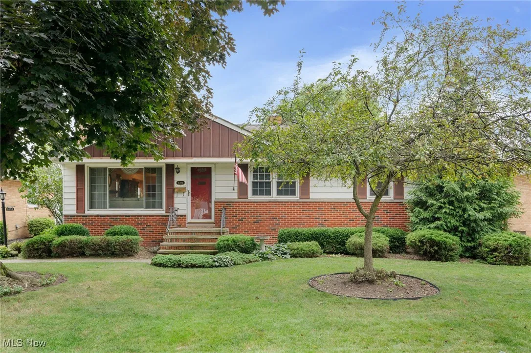 View of front facade featuring brick siding and a front lawn
