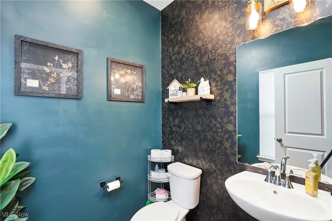 1/2 Bathroom with wallpapered walls