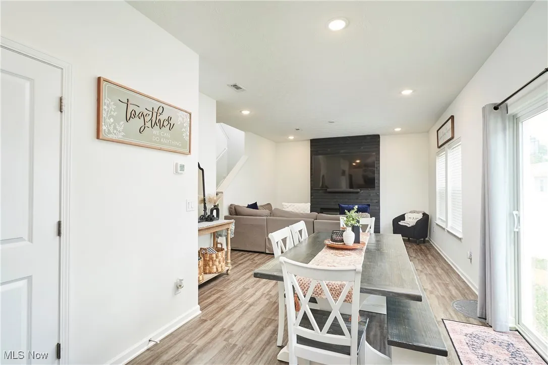 Dining area featuring light LVP wood-type flooring and recessed lighting