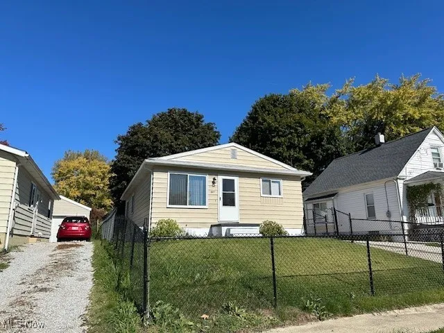Bungalow-style house featuring a front lawn