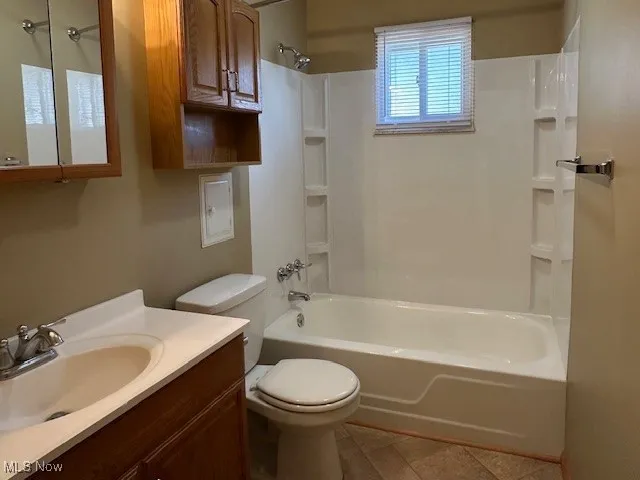 Full bathroom with vanity, toilet, and washtub / shower combination
