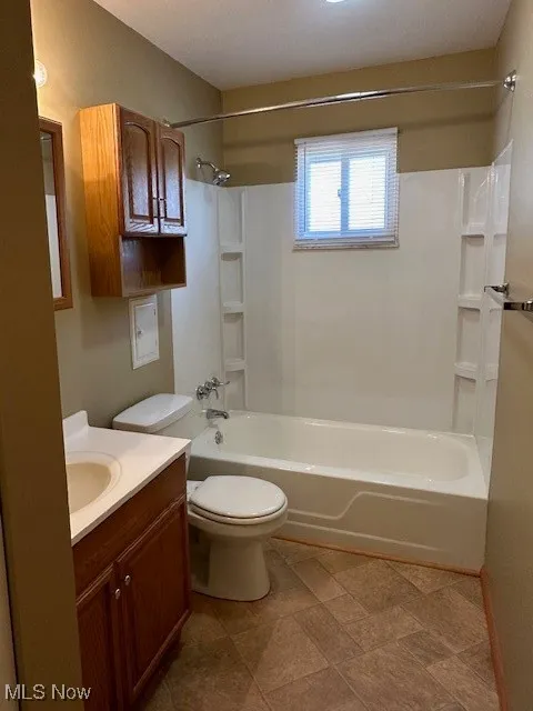 Full bathroom with vanity, shower / bathing tub combination, and toilet