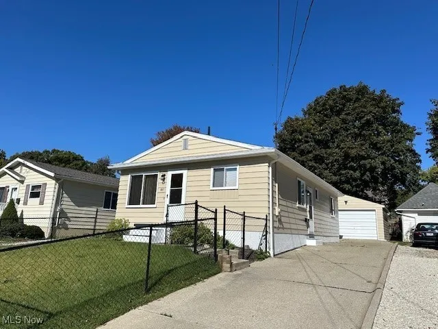 View of front facade with a front lawn and a garage
