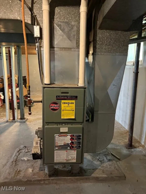 Utility room featuring heating unit
