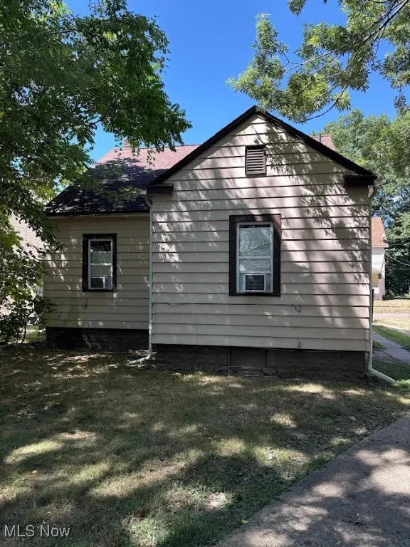 View of side of property with a yard