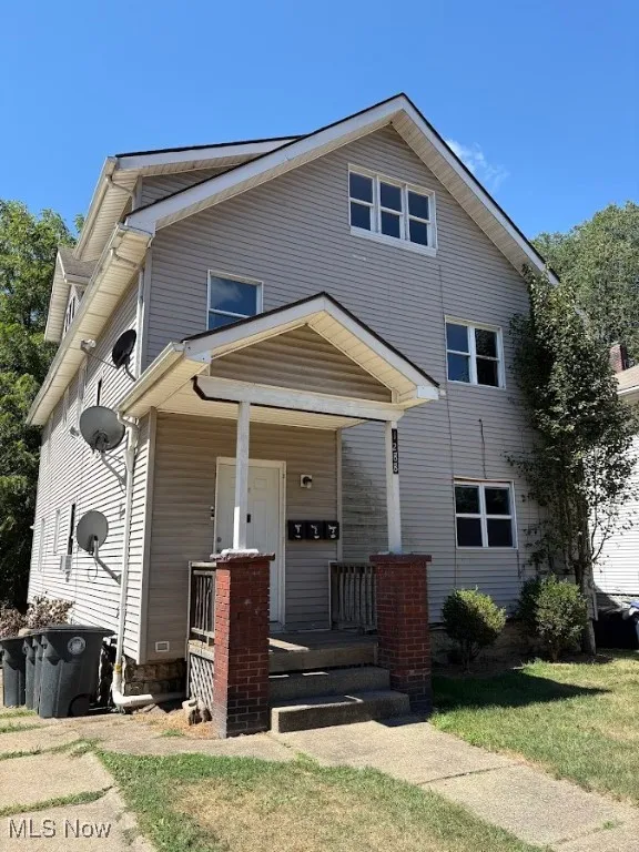 View of front facade featuring a porch and a front lawn