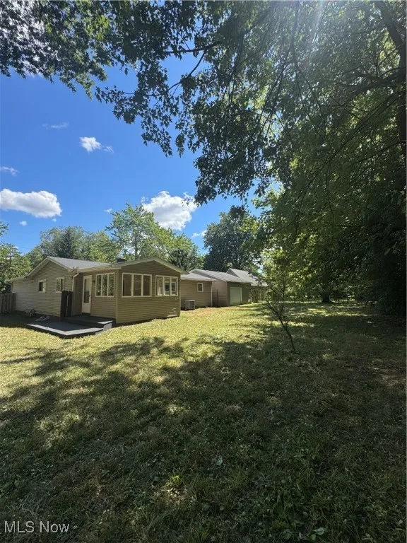 View of grassy yard with a garage