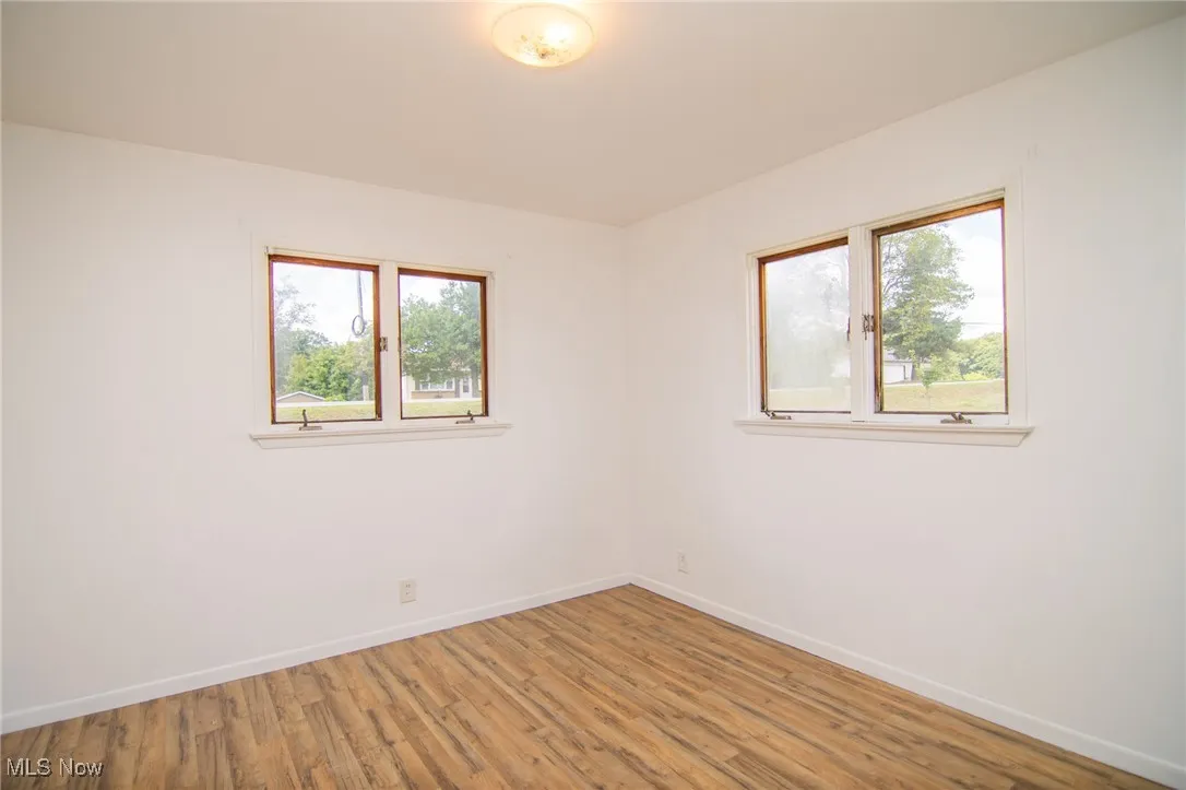 Spare room with wood finished floors and baseboards