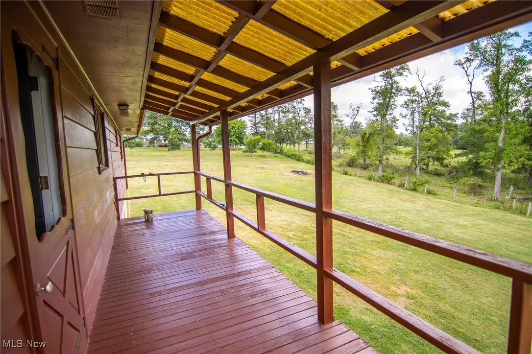 Wooden terrace with a lawn