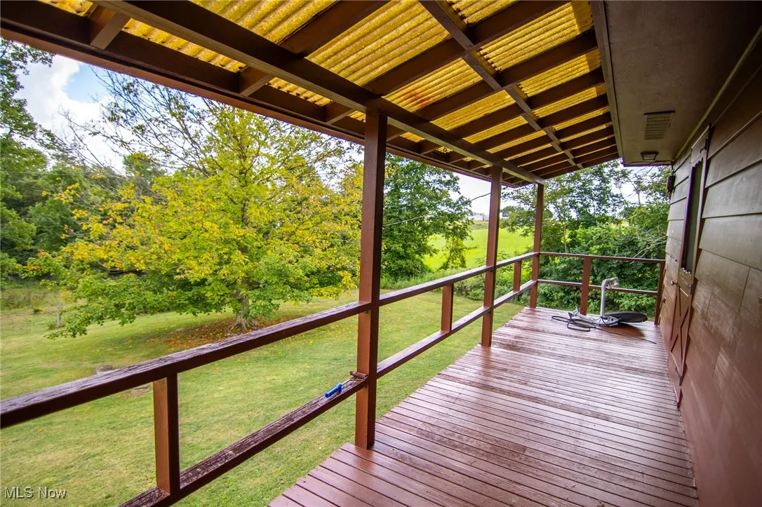 Wooden terrace with a yard