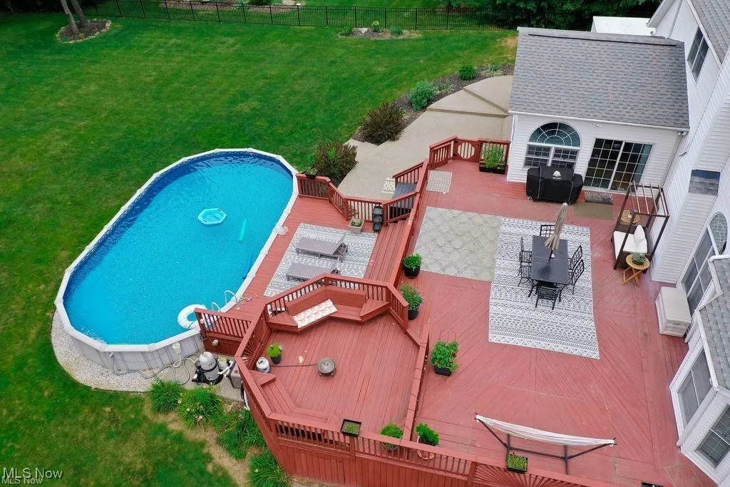 View of swimming pool featuring a deck, outdoor dining space, and a patio