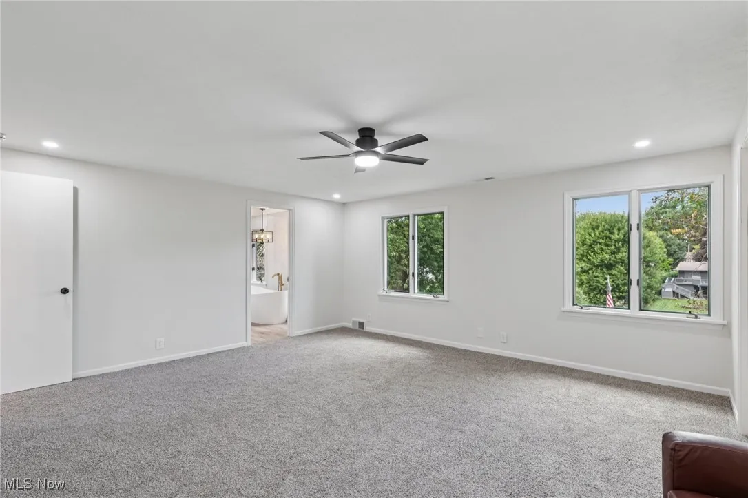 Unfurnished room featuring light carpet, recessed lighting, and a ceiling fan