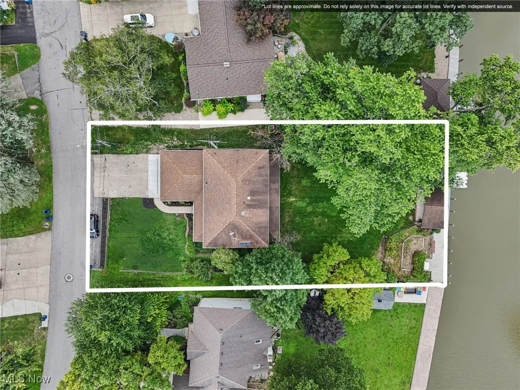 Aerial perspective of suburban area featuring property parcel outlined