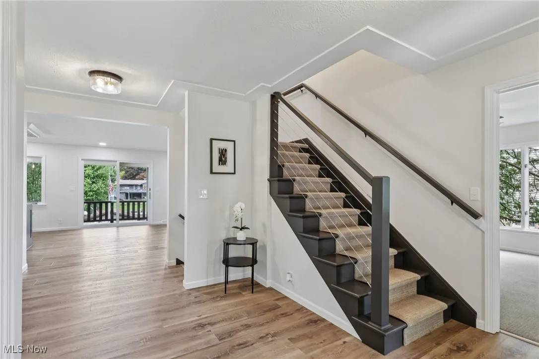 Staircase featuring wood finished floors and baseboards