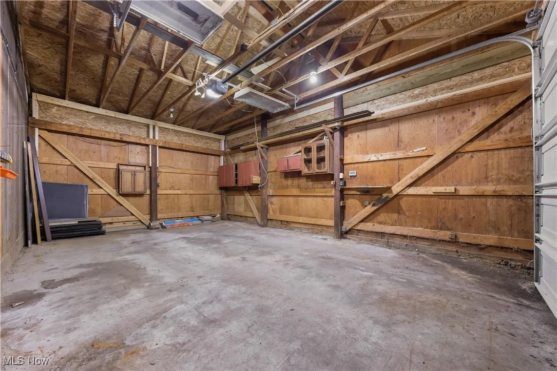 3rd car garage featuring a raised roof to accommodate a large van or small RV