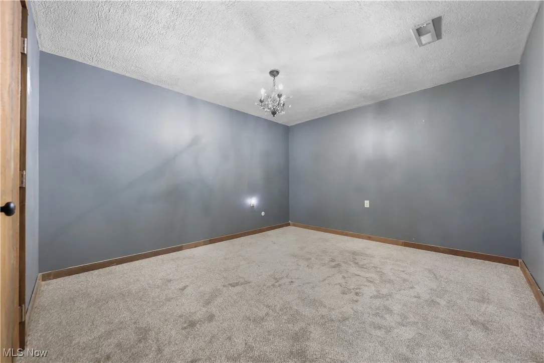 New carpet in 4th bedroom/2nd living suite with closet and a chandelier in LL