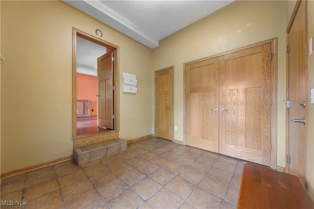Spacious foyer with ceramic tile, plenty of storage and access to the garage