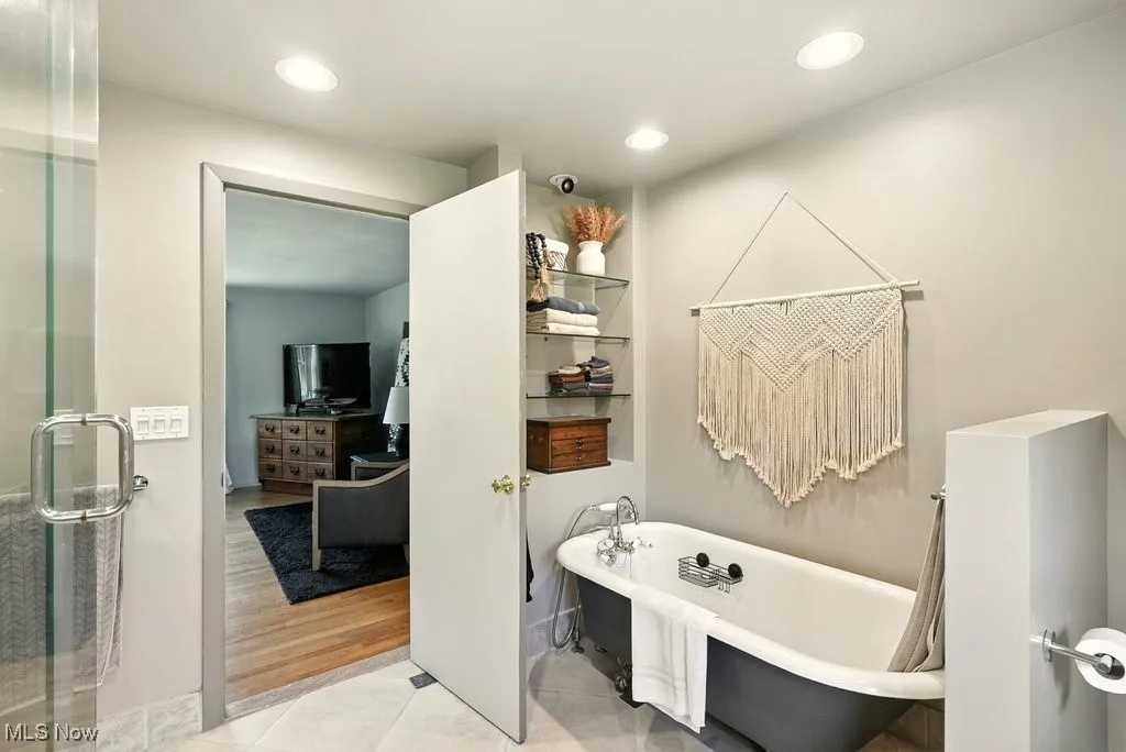 Bathroom featuring a soaking tub, tile patterned floors, recessed lighting, and a shower stall