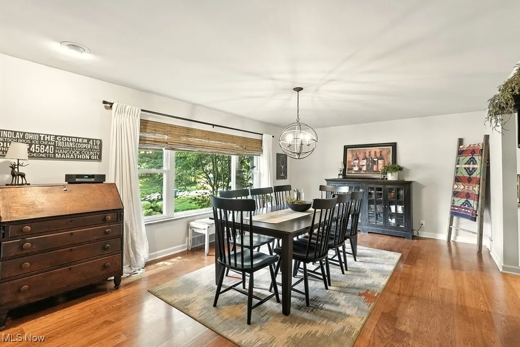 Dining area featuring light wood-style floors and a chandelier