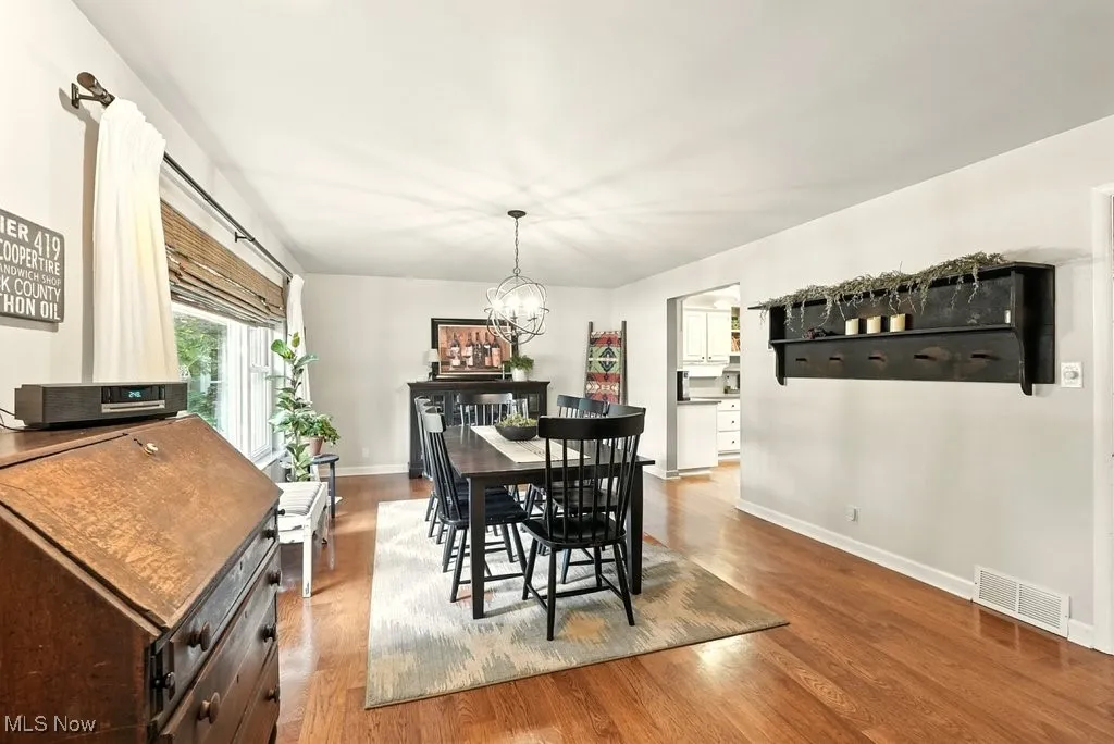 Dining room featuring light wood finished floors and a chandelier