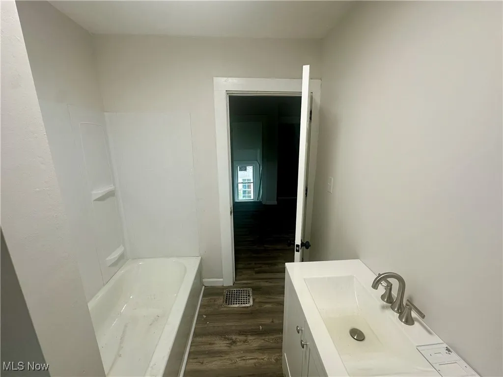 Bathroom with vanity and dark wood-style flooring
