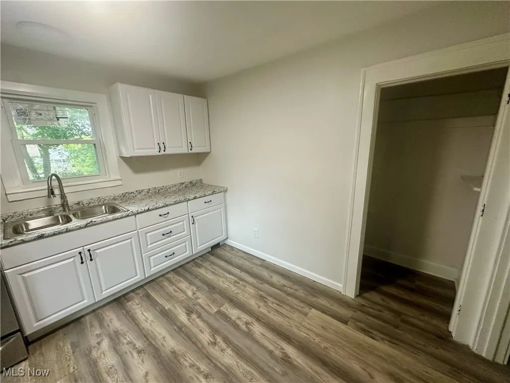 Kitchen featuring white cabinets and light wood-style flooring