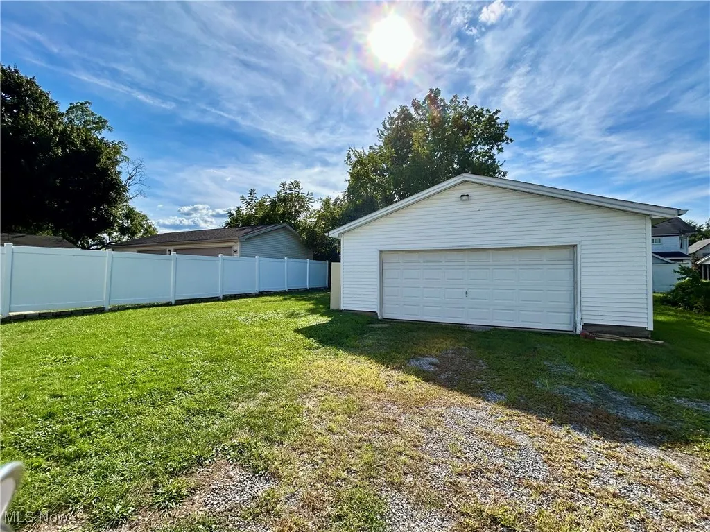 View of detached garage and large back yard