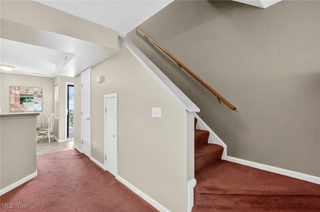 Stairway featuring carpet flooring