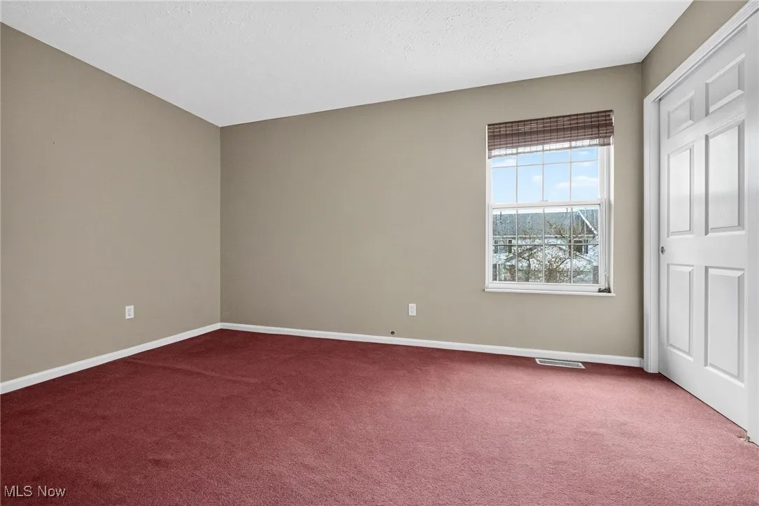 Unfurnished bedroom with carpet flooring and a textured ceiling