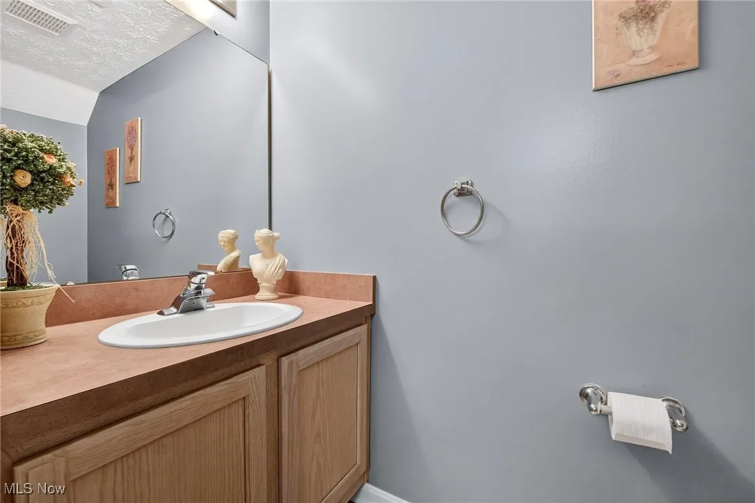 Bathroom with vanity and a textured ceiling
