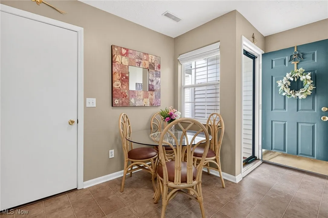 Tiled dining room with baseboards