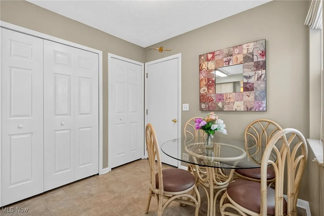 Dining area featuring a textured ceiling and light tile patterned floors