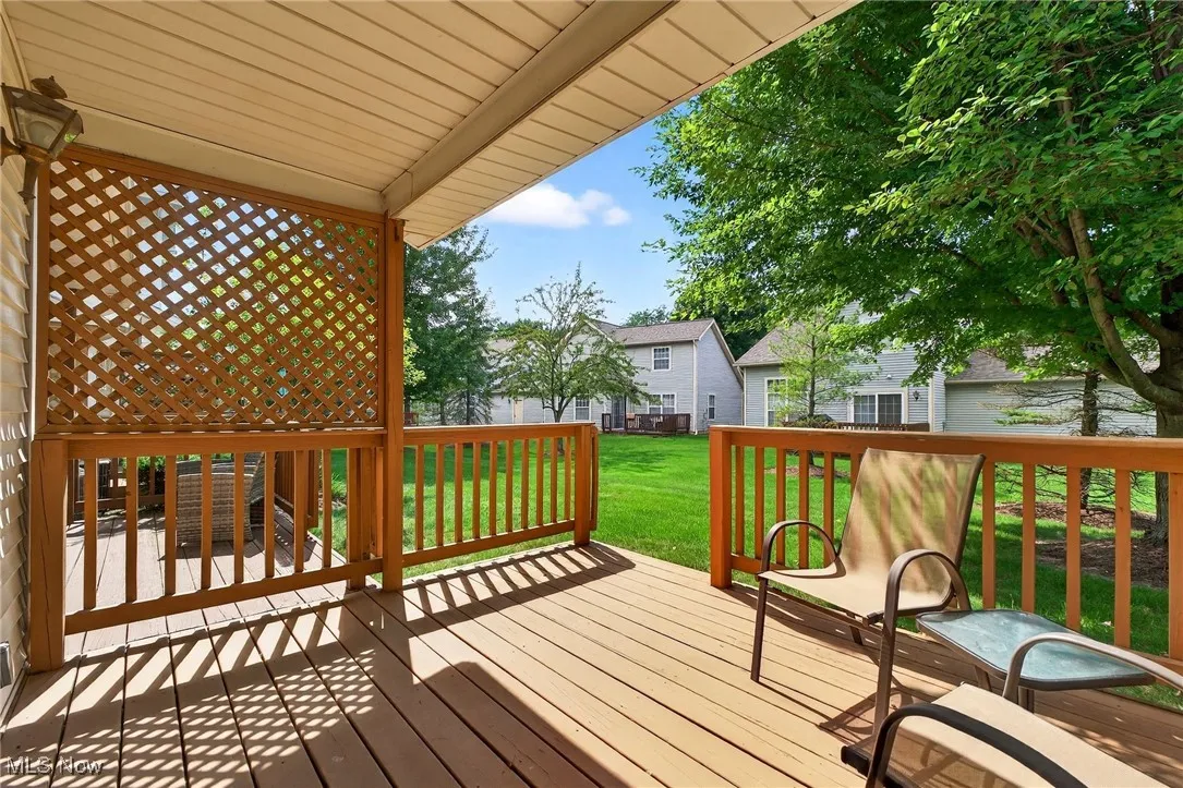 Wooden terrace featuring a lawn