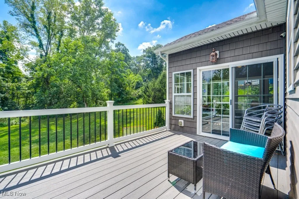 Deck with a lawn and view of scattered trees