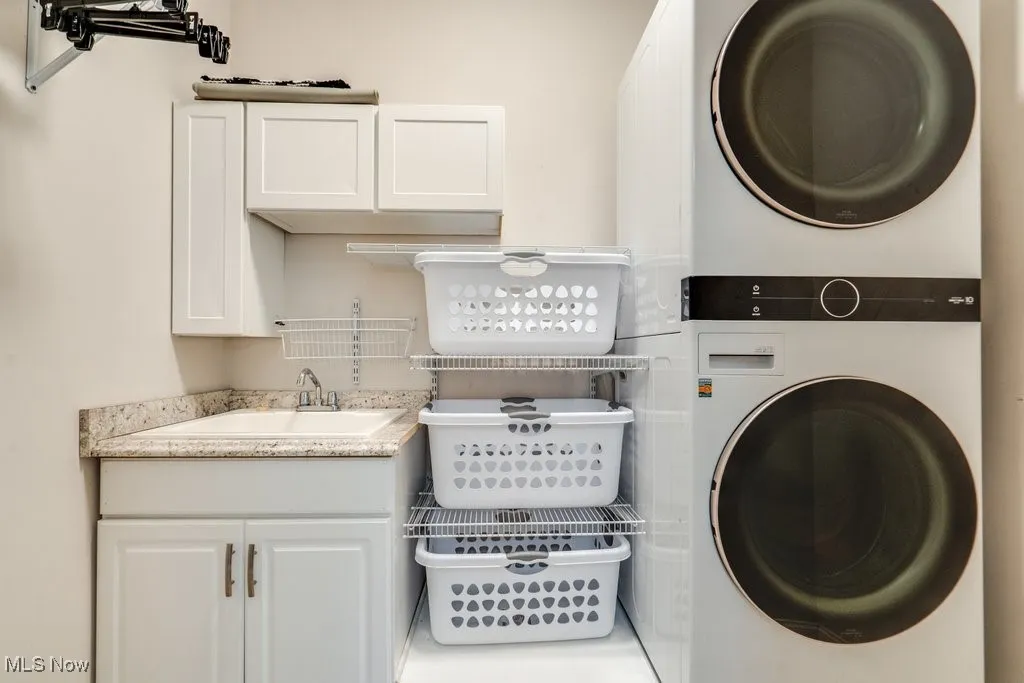 Laundry room with cabinet space and estacked washer and dryer
