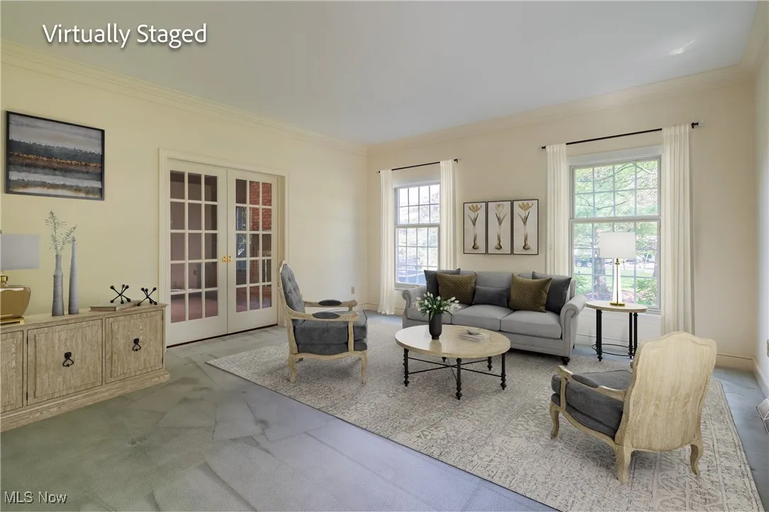 Formal Living Room with custom painted molding. Glass French doors open to the Family Room.