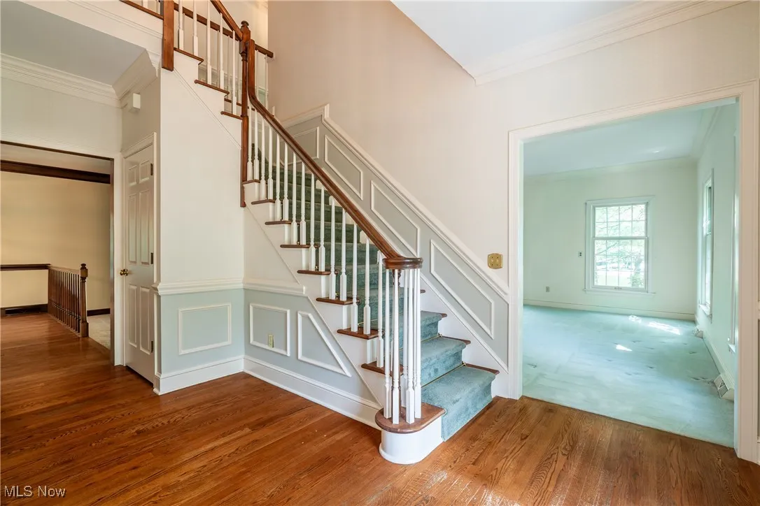 Gracious Foyer with hardwood floors and turned staircase.