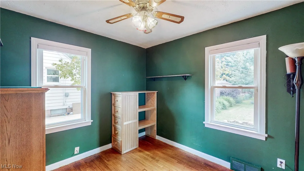 Unfurnished bedroom featuring hardwood finished floors and ceiling fan